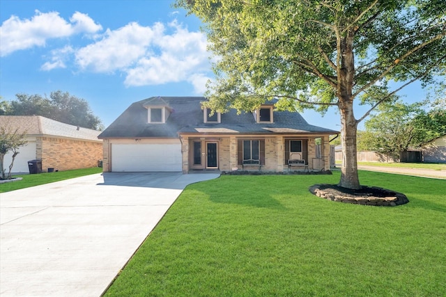 view of front of home with a front yard, brick siding, a garage, and driveway