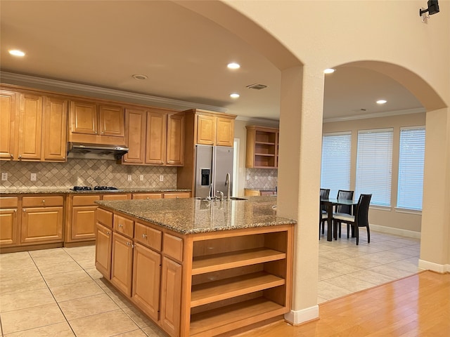 kitchen featuring visible vents, crown molding, under cabinet range hood, stainless steel appliances, and open shelves