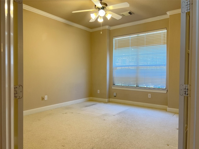 carpeted empty room featuring visible vents, baseboards, ornamental molding, and a ceiling fan