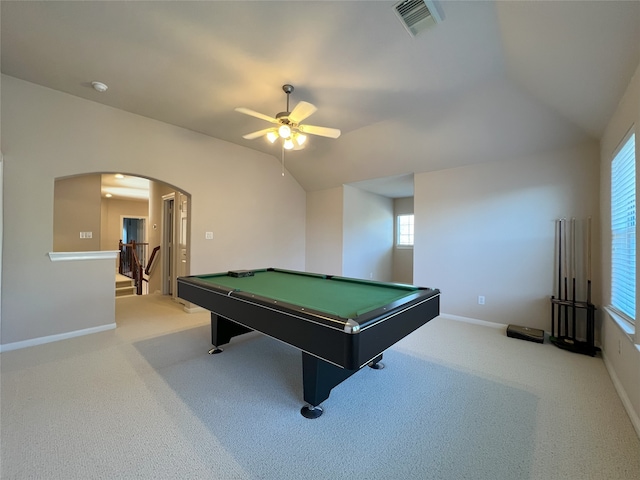 playroom featuring arched walkways, visible vents, light colored carpet, and vaulted ceiling