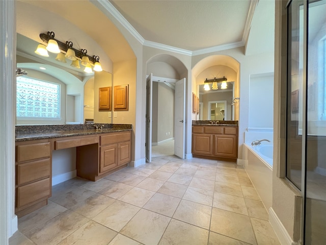 full bath with a garden tub, two vanities, a sink, crown molding, and baseboards