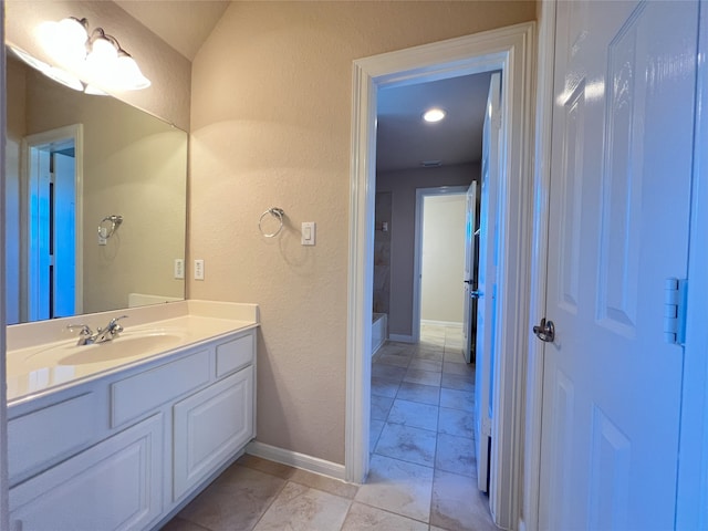 bathroom with vanity and baseboards