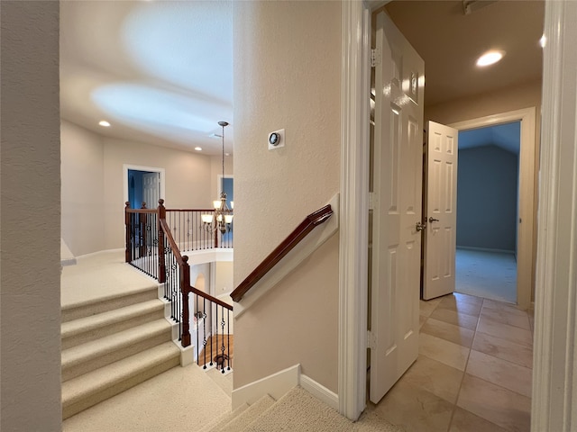 staircase featuring recessed lighting, baseboards, an inviting chandelier, and tile patterned flooring