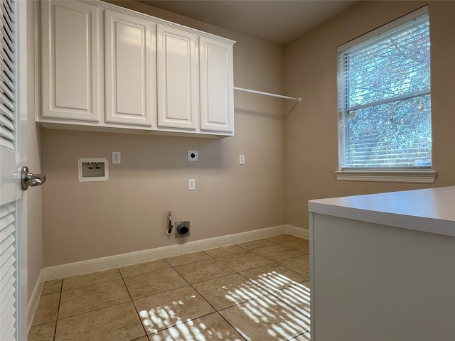 washroom with washer hookup, light tile patterned flooring, cabinet space, and electric dryer hookup