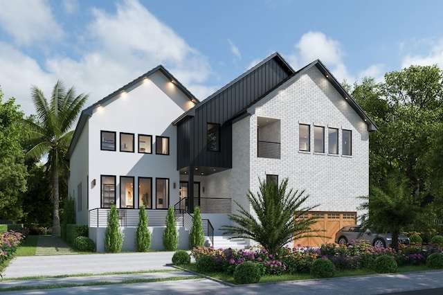 modern inspired farmhouse featuring brick siding and board and batten siding