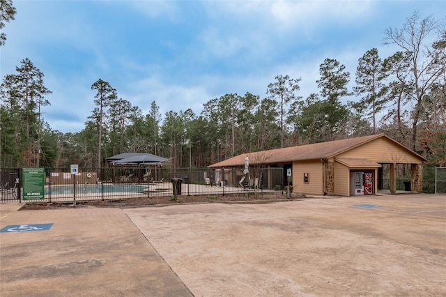 exterior space featuring a pool and fence