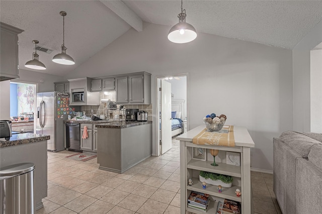 kitchen with light tile patterned floors, visible vents, beam ceiling, gray cabinetry, and appliances with stainless steel finishes