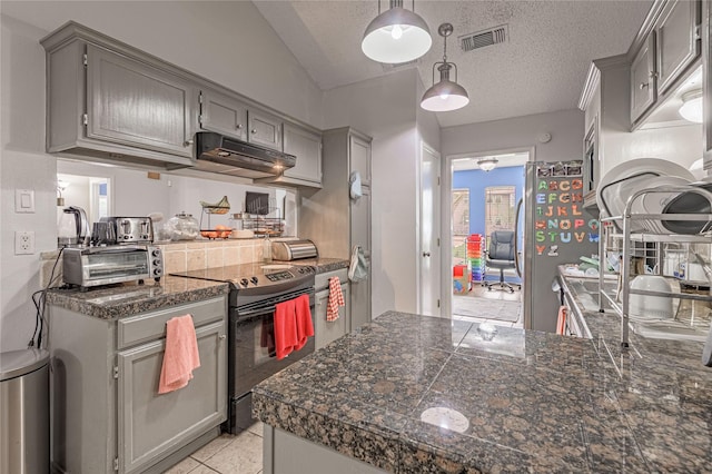 kitchen featuring under cabinet range hood, electric range, gray cabinetry, and visible vents