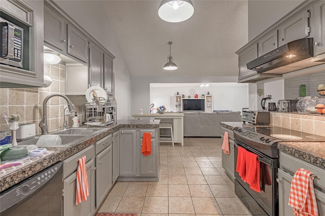 kitchen featuring gray cabinetry, under cabinet range hood, light tile patterned floors, black appliances, and a sink