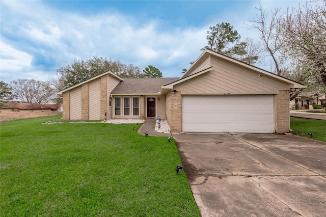 view of front facade with concrete driveway, an attached garage, brick siding, and a front lawn