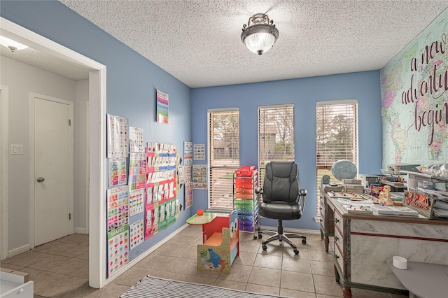 tiled office space with baseboards and a textured ceiling