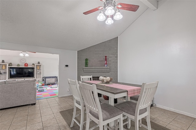 dining space featuring light tile patterned floors, baseboards, ceiling fan, vaulted ceiling, and a textured ceiling