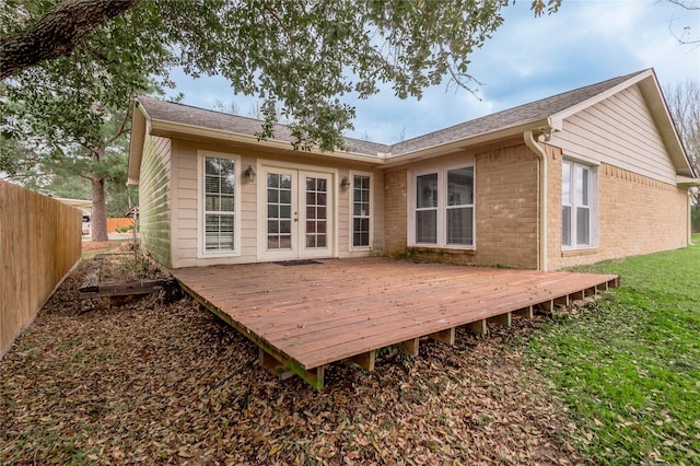 rear view of house featuring brick siding, fence, french doors, a yard, and a deck