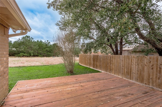 deck with a yard and fence