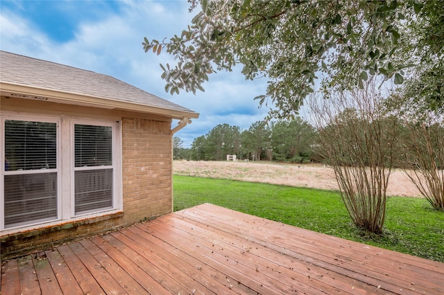 wooden deck featuring a yard