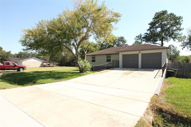 single story home featuring a front yard, fence, driveway, stucco siding, and a garage