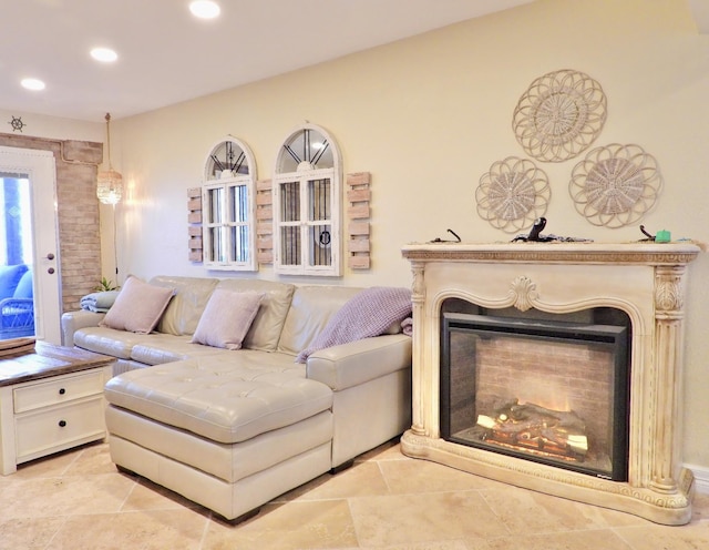 living room featuring a glass covered fireplace and recessed lighting