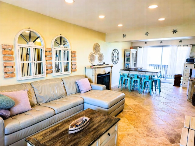 living room featuring recessed lighting and a fireplace