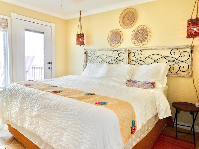 bedroom featuring crown molding and wood finished floors