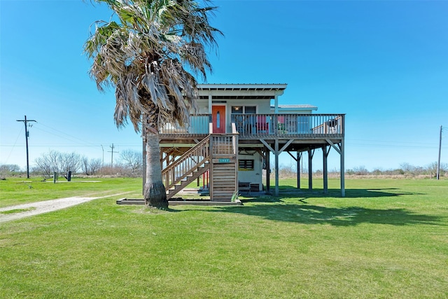 exterior space featuring stairway, metal roof, a deck, and a front yard