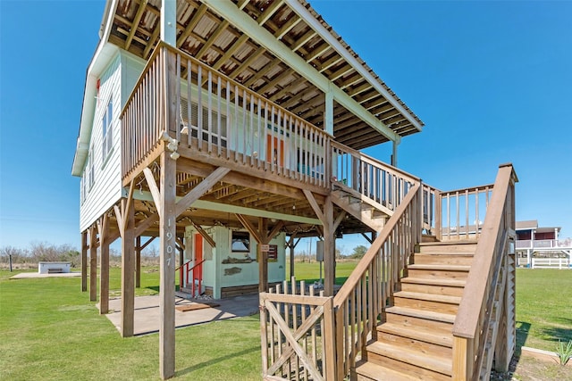 exterior space with stairway, a lawn, and a patio area