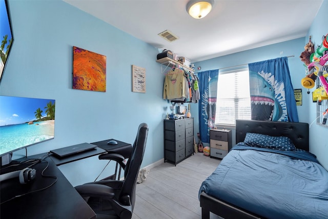 bedroom with visible vents and light wood-style flooring