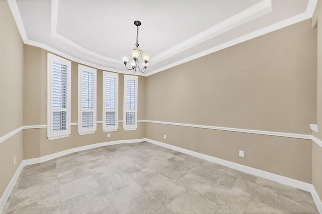 empty room with a tray ceiling, baseboards, a notable chandelier, and ornamental molding