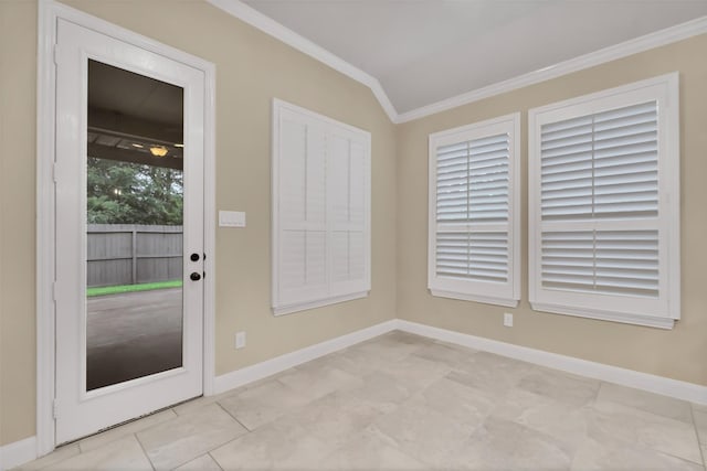 entryway with baseboards, lofted ceiling, and crown molding