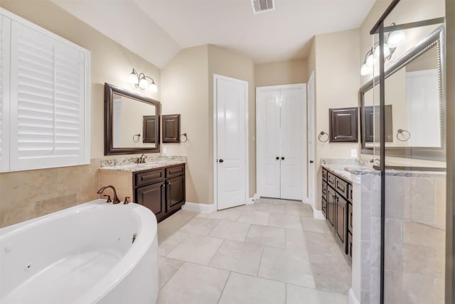 full bathroom featuring tile patterned floors, visible vents, two vanities, a sink, and a whirlpool tub