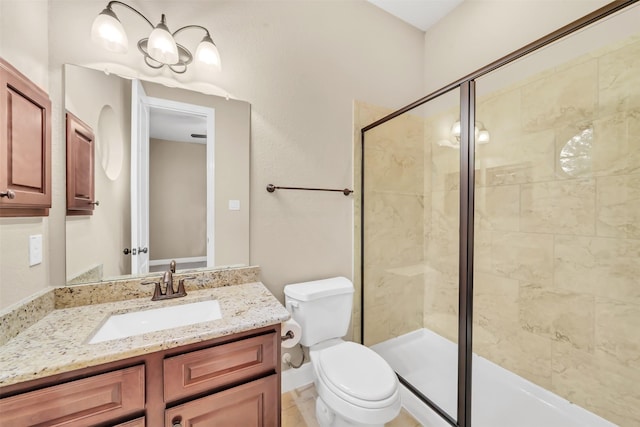 bathroom with a shower stall, toilet, and vanity