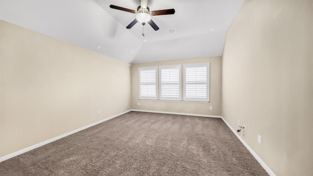 unfurnished room with visible vents, baseboards, carpet floors, vaulted ceiling, and a ceiling fan