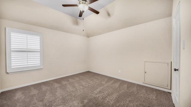 carpeted spare room with baseboards, ceiling fan, and vaulted ceiling