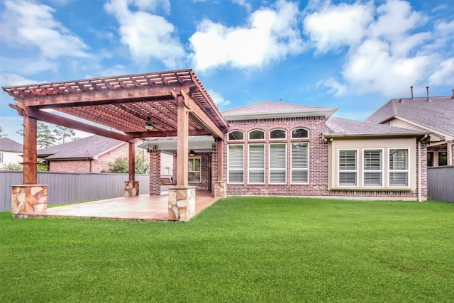 back of house with a patio, fence, a pergola, a lawn, and brick siding