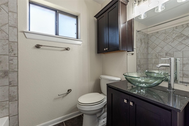 bathroom featuring a shower, baseboards, toilet, and vanity