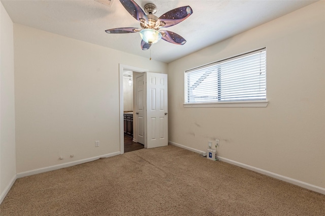 unfurnished bedroom featuring carpet flooring, ceiling fan, ensuite bath, and baseboards