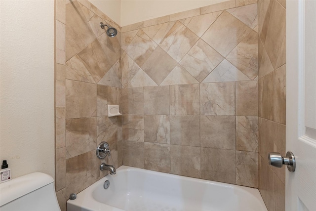 bathroom featuring toilet and  shower combination