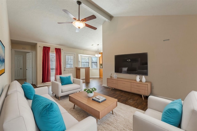 living room featuring a ceiling fan, wood finished floors, baseboards, vaulted ceiling with beams, and a textured ceiling