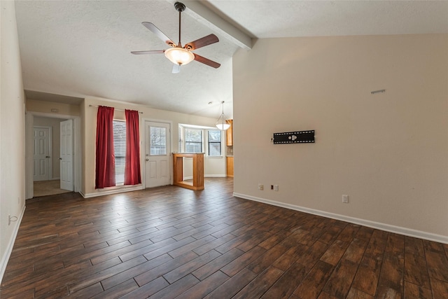 unfurnished living room with a ceiling fan, baseboards, dark wood finished floors, vaulted ceiling with beams, and a textured ceiling