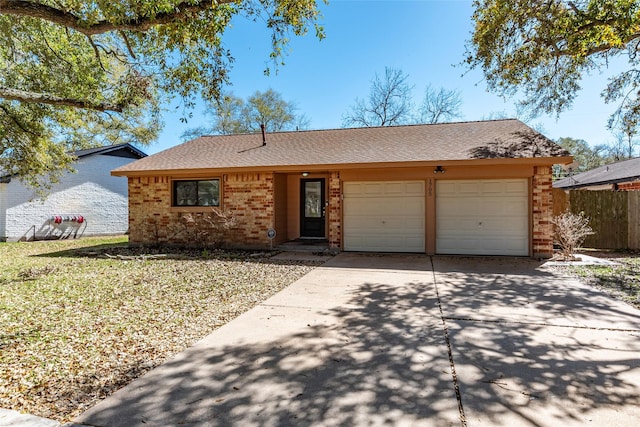 ranch-style house featuring fence, driveway, roof with shingles, a garage, and brick siding