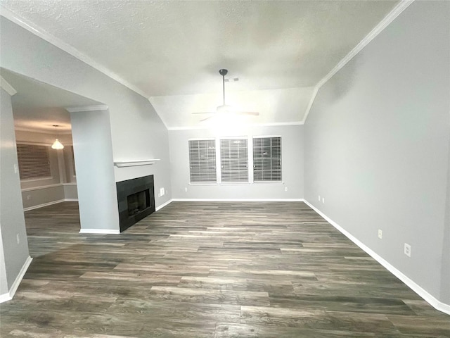 unfurnished living room featuring ornamental molding, a ceiling fan, wood finished floors, a fireplace, and vaulted ceiling