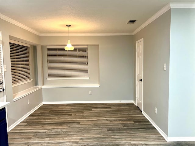 unfurnished dining area with visible vents, a textured ceiling, wood finished floors, and crown molding