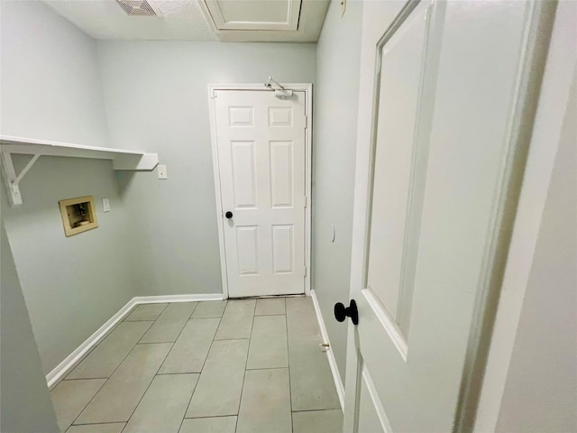 washroom with light tile patterned flooring, baseboards, hookup for a washing machine, and laundry area