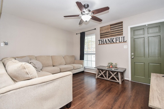 living area with a ceiling fan, dark wood-style flooring, and baseboards