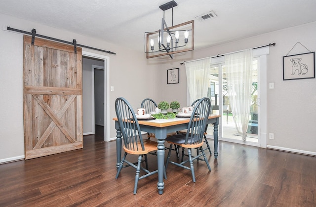 dining area with a barn door, baseboards, visible vents, and dark wood-style flooring