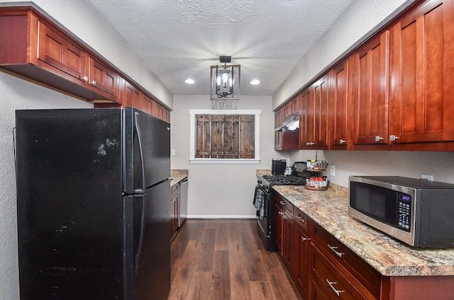 kitchen with baseboards, dark wood-type flooring, black appliances, and a textured ceiling