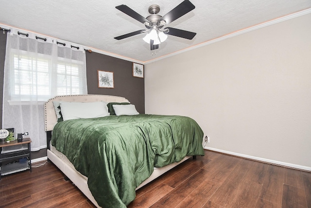 bedroom featuring baseboards, wood finished floors, and crown molding