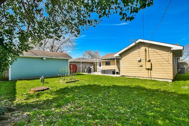 view of yard with a patio area, cooling unit, and fence