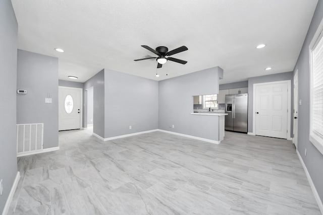 unfurnished living room featuring recessed lighting, visible vents, baseboards, and a ceiling fan