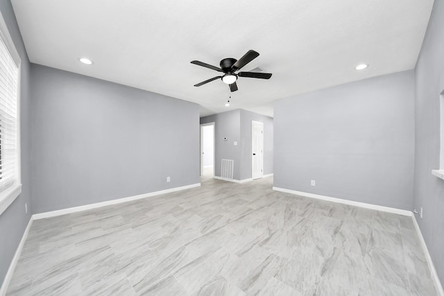 unfurnished room featuring plenty of natural light, baseboards, visible vents, and ceiling fan