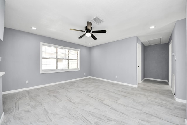 empty room featuring attic access, recessed lighting, baseboards, and visible vents